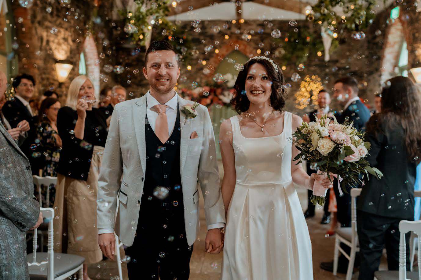 Wedding ceremony celebration with confetti bubbles at Orange Tree House stone barn wedding venue Northern Ireland