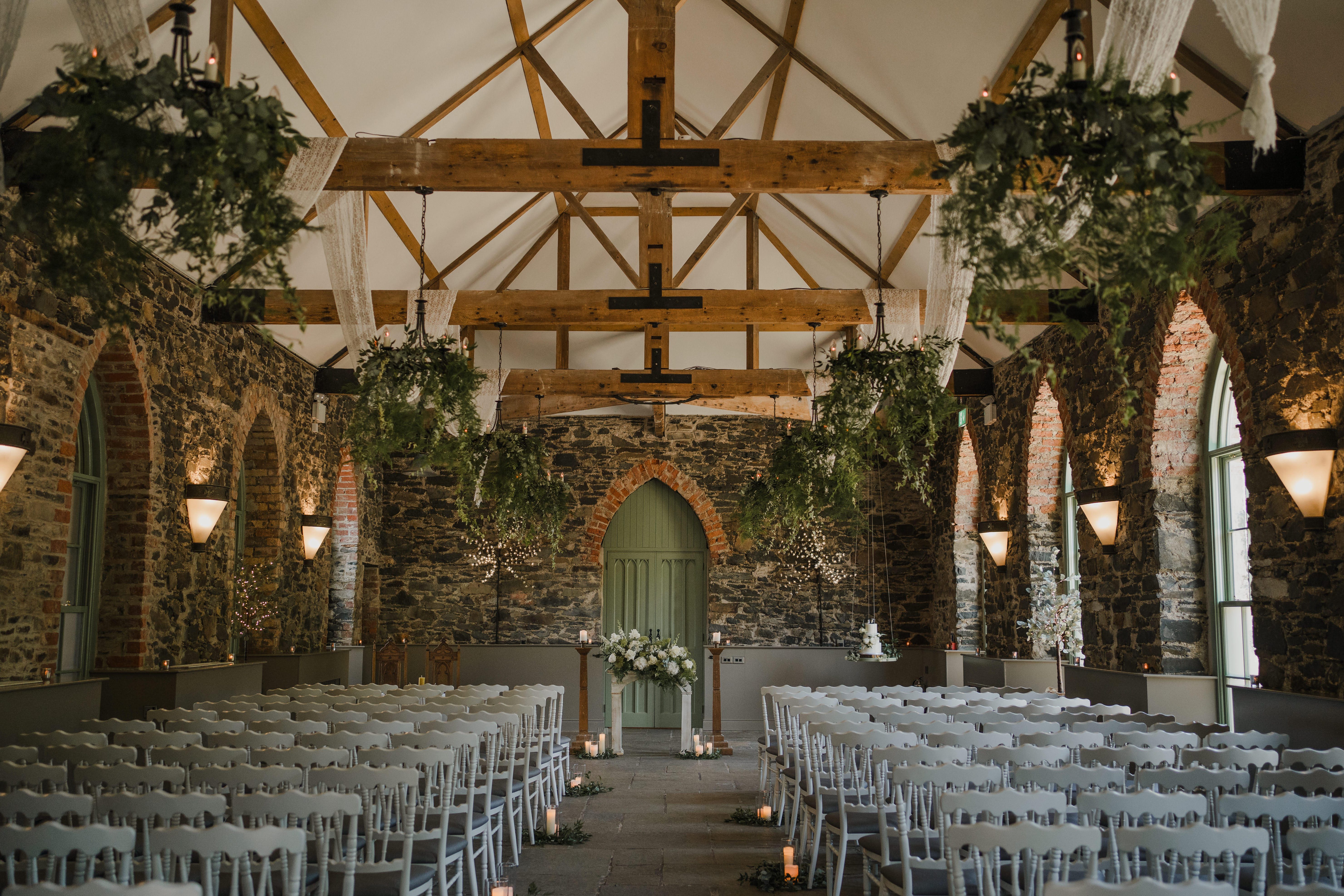 Stone barn wedding ceremony setup at Orange Tree House exclusive use wedding venue Northern Ireland