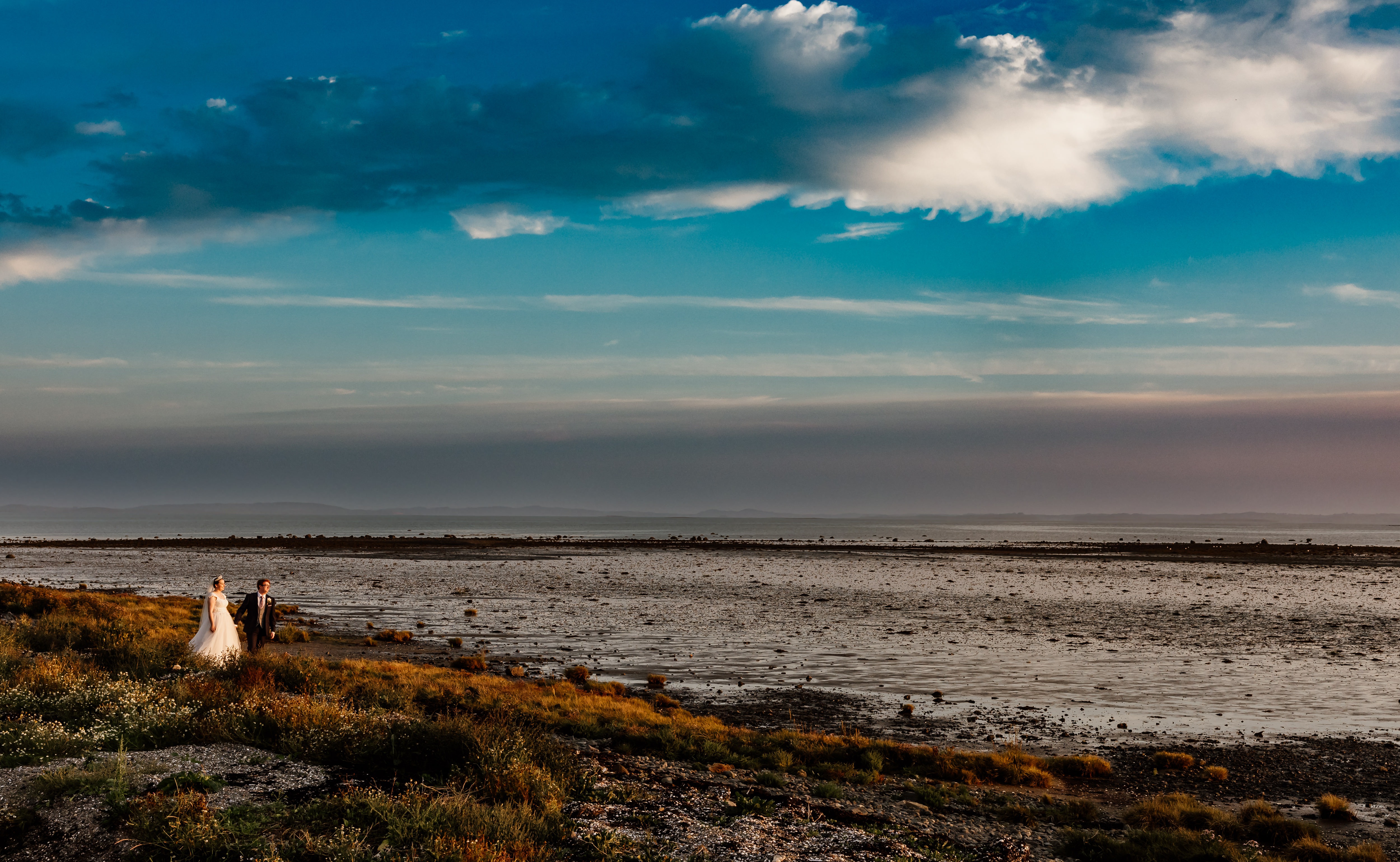 Couple wedding photos on shoreline at Orange Tree House coastal wedding venue Northern Ireland 